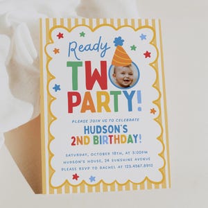 May include: A rectangular birthday invitation card with yellow and white vertical stripes on the border. The text reads Ready TWO PARTY! Hudson's 2nd Birthday, Saturday, October 18th, at 3:00PM, Hudson's house, 24 Sunshine Avenue, RSVP to Rachel at 123.4567.8910.