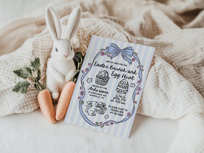 May include: A white plush bunny with long ears sits next to two orange carrots and an Easter Brunch and Egg Hunt invitation. The invitation has a blue striped background and features a bow, flowers, and Easter-themed illustrations.