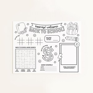 May include: Black and white back-to-school placemat with the text "hooray! welcome BACK TO SCHOOL!". Includes a tic-tac-toe game, word search, maze, word scramble, and a space to draw a summer memory. Features illustrations of a backpack, pencil, and stars.