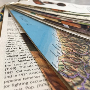May include: A close-up of a map of South America, with a blue and white map of the Pacific Ocean in the background. The map shows the country of Peru, with the city of Arequipa highlighted. The map is made of paper and has a vintage look.