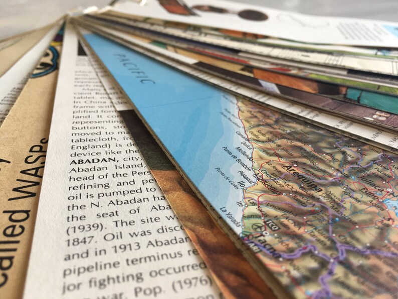 May include: A close-up of a map of South America, with a blue and white map of the Pacific Ocean in the background. The map shows the country of Peru, with the city of Arequipa highlighted. The map is made of paper and has a vintage look.