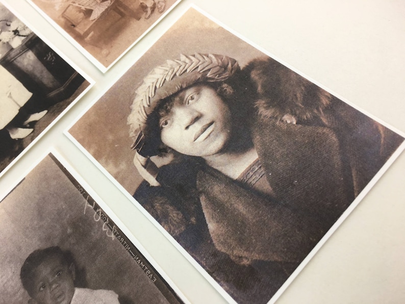 May include: A sepia-toned portrait of a person wearing a woven hat and a fur-trimmed coat. The person is looking directly at the camera.