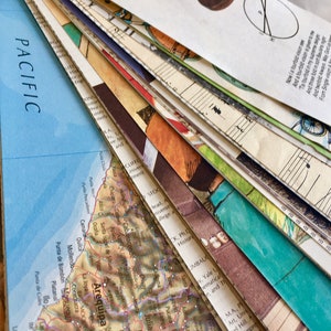 May include: A close-up of a stack of vintage paper ephemera, including a map of the coast of Peru with the city of Arequipa highlighted, a sheet of music, and a page of text. The papers are arranged in a fan shape, with the map at the bottom and the text at the top.