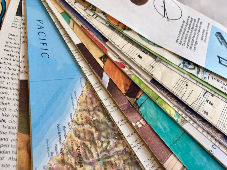 May include: A close-up of a stack of vintage paper ephemera, including a map of the coast of Peru with the city of Arequipa highlighted, a sheet of music, and a page of text. The papers are arranged in a fan shape, with the map at the bottom and the text at the top.