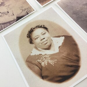 May include: A sepia-toned portrait of a woman with a lace collar and a beaded embellishment on her dress.