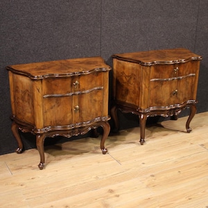 May include: Two antique wooden nightstands. Each nightstand has a curved top, two drawers, and ornate legs. The wood has a rich, warm brown tone with visible grain patterns. The hardware is a gold color.