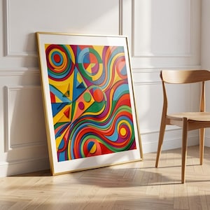 Puede incluir: Una impresión artística abstracta enmarcada con un marco dorado. La obra de arte presenta un diseño vibrante y colorido con líneas onduladas, formas geométricas y una mezcla de tonos rojos, amarillos, azules, verdes y morados. La impresión se apoya en una pared blanca.