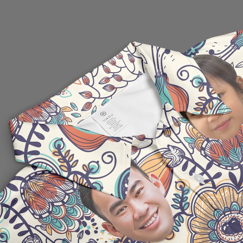 May include: A white polo shirt with a colorful floral pattern. The pattern features orange, blue, and green colors. Two faces are visible in the pattern.