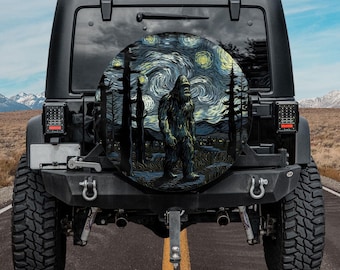 May include: Black Jeep with a spare tire cover featuring a Bigfoot illustration in a starry night scene. The artwork includes dark trees, a village, and a swirling sky in shades of blue, green, and yellow.