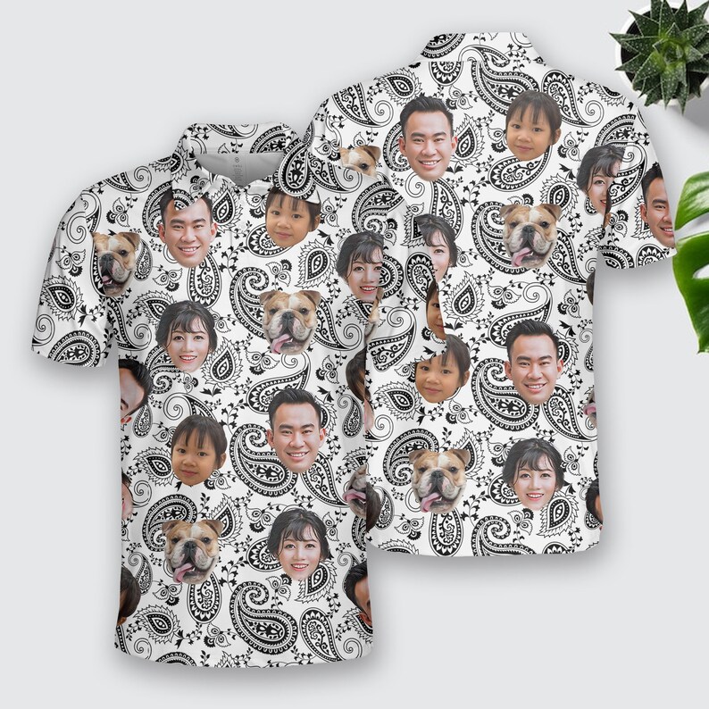 May include: White short-sleeved button-up shirt with a paisley pattern. The pattern features various faces of people and dogs.