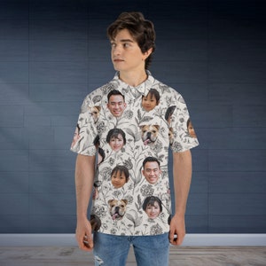 May include: A white button-down shirt with a unique pattern featuring faces of people and a dog. The faces are printed in black and white on a white background.