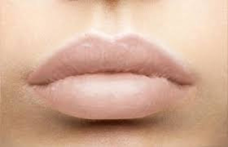 May include: Close-up of nude-coloured lips with a glossy finish.
