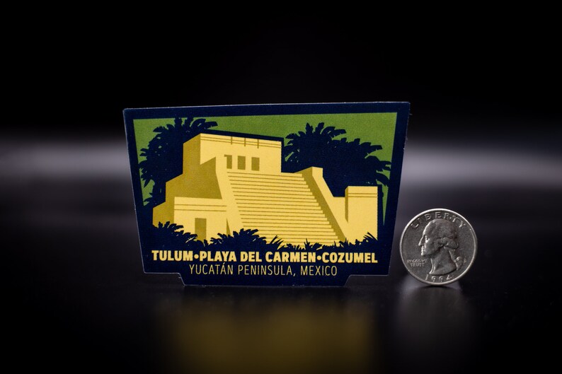May include: A blue and green sticker with a yellow illustration of a Mayan pyramid and palm trees. The sticker reads "Tulum-Playa del Carmen-Cozumel Yucatan Peninsula, Mexico".