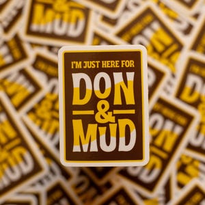 May include: A square sticker with the text "I'M JUST HERE FOR DON & MUD" in yellow and white on a brown background. The sticker is surrounded by other stickers with the same design, creating a repeating pattern.