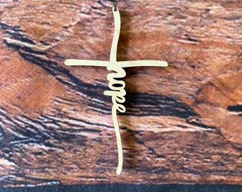 May include: A wooden cross with the word "Hope" written in a cursive font on the vertical beam.