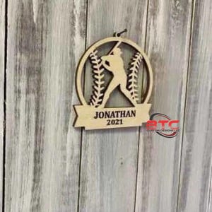 May include: Wooden baseball ornament with a baseball player silhouette and the text "JONATHAN 2021".