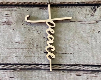 May include: A wooden cross with the word "peace" written vertically down the center.