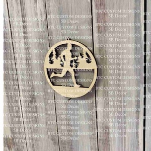 May include: A wooden ornament featuring a silhouette of a runner in a forest setting. The ornament is circular and has a hole at the top for hanging.