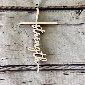 K&ouml;nnte beinhalten: Holzkreuz mit dem Wort "St&auml;rke" vertikal in der Mitte geschrieben.