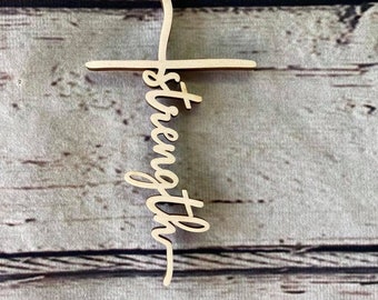 May include: Wooden cross with the word "strength" written vertically down the center.