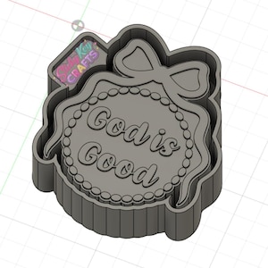May include: A gray cookie cutter with the words "God is Good" in a script font. The cutter has a bow at the top and a beaded border. The cutter is in a rectangular shape.