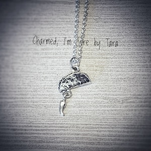 Taco charm necklace with dangling jalapeño pepper.