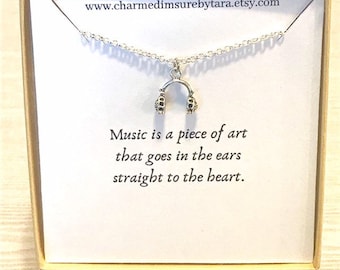 Tiny headphone charm necklace on a sentiment card.
