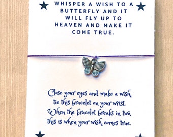 May include: A purple string bracelet with a silver butterfly charm. The card attached to the bracelet reads "Whisper a wish to a butterfly and it will fly up to heaven and make it come true. Close your eyes and make a wish tie this bracelet on your wrist. When the bracelet breaks in two, this is when your wish comes true."