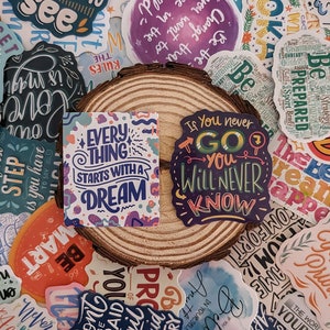 May include: A collection of colorful stickers with motivational quotes and phrases. The stickers feature a variety of fonts and designs, including a sticker that says "Every thing starts with a dream" and another that says "If you never go you will never know".