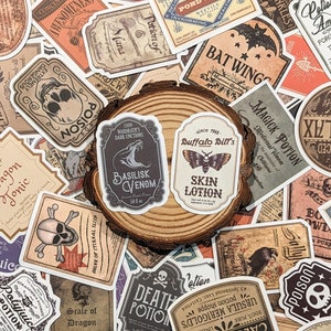 May include: A collection of vintage-style stickers featuring potion labels with names like "Basilisk Venom", "Death Potion", "Bat Wings", and "Magick Potion". The stickers are printed on white paper with black and brown ink and have a distressed, aged look.