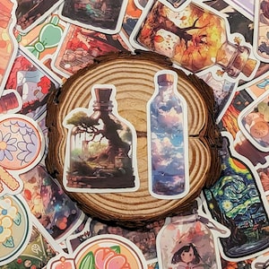 May include: A collection of colorful stickers featuring various designs, including a glass bottle with a tree inside, a glass bottle with a sky inside, a snow globe with pink flowers, and a glass bottle with a girl inside. The stickers are arranged on a wooden surface.