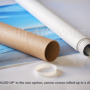 May include: A rolled up canvas print with a blue and white seascape design. The canvas is rolled up in a brown cardboard tube and secured with a white plastic cap. The text "Smile Art Design" is visible on the tube.