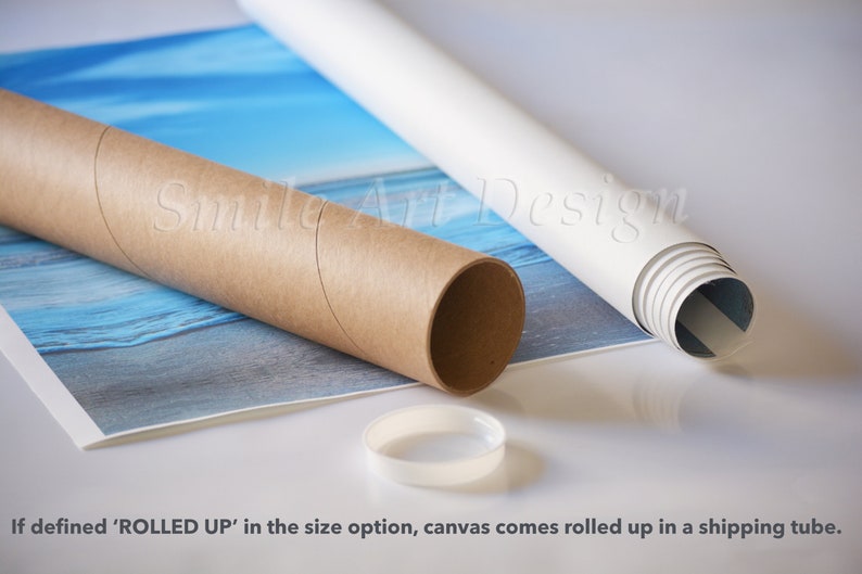 May include: A rolled up canvas print with a blue and white seascape design. The canvas is rolled up in a brown cardboard tube and secured with a white plastic cap. The text "Smile Art Design" is visible on the tube.