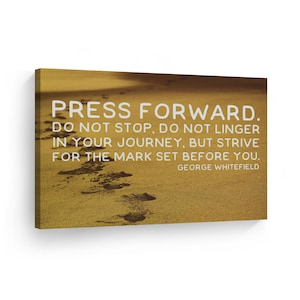 May include: A motivational quote on a canvas print with a sandy beach background. The quote reads "Press forward. Do not stop, do not linger in your journey, but strive for the mark set before you." - George Whitefield.