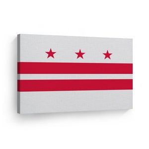 May include: A rectangular canvas print featuring the flag of Washington, D.C. The flag has a white background with three red stars at the top and two horizontal red stripes across the center.