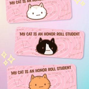 May include: Three pink rectangular stickers with the text "MY CAT IS AN HONOR ROLL STUDENT" and cat illustrations. Each sticker features a different cat: white, black and white, and orange. Mathematical symbols and equations are in the background.