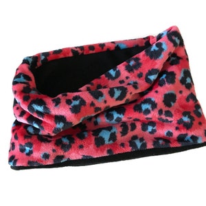 May include: A pink and blue leopard print fleece neck warmer with a black fleece lining.