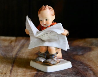 hummel boy reading newspaper