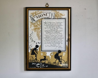 May include: Framed artwork with a gold border featuring a poem dedicated to "MOM." The artwork includes silhouettes of children, a dog, and decorative elements in black and gold. The text reads "As Mom I love you best."