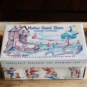 May include: Vintage Mother Goose Shoes box with a colorful illustration. The box features a whimsical scene with a shoe-shaped house and children playing. Text on the box reads "Especially Designed for Growing Feet."