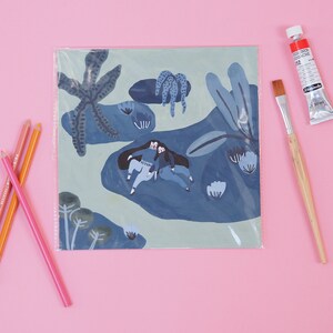 May include: A blue and green illustration of two people sitting on a blue rock surrounded by blue and green plants. The illustration is printed on a white card and is protected by a clear plastic sleeve.