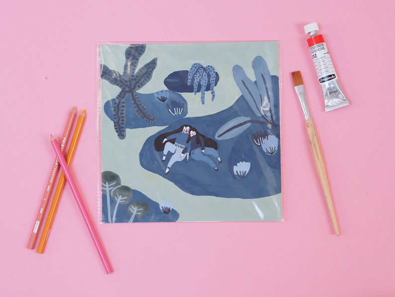 May include: A blue and green illustration of two people sitting on a blue rock surrounded by blue and green plants. The illustration is printed on a white card and is protected by a clear plastic sleeve.