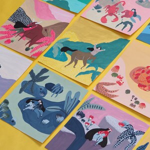 May include: A set of colorful illustrated cards featuring various scenes with people, animals, and plants. The cards are painted in a whimsical style with bright colors and bold lines.