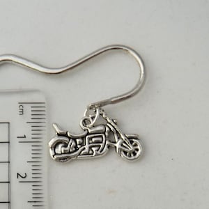 May include: Silver bookmark with a motorcycle charm. The bookmark is approximately 5 cm long and has a hook at the top.