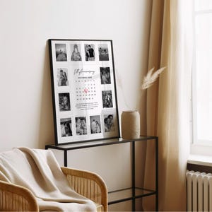 May include: A framed black and white photo collage commemorating a 1st anniversary. The collage features multiple small photos arranged around a calendar with the text "1st Anniversary October 2025". The frame is displayed on a glass-topped table.