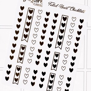 May include: Foiled heart checklists planner stickers with black and white hearts in various sizes and arrangements. The stickers are on a clear sheet with the text "Foiled Heart Checklists" and "I Adore Planning" printed on it.