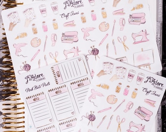May include: A set of pink note pads with the text "J'Adore Planning Pink Note Pads" and the word "NOTES" on each pad. There are also two sheets of craft stickers with the text "J'Adore Planning Craft Icons" and various craft-themed illustrations.