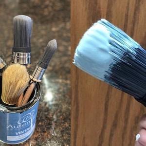 May include: Four paint brushes in a can of black paint. The can has a blue label with the text "Authentic  Decorative  Vintage". A paint brush with blue paint on the bristles.