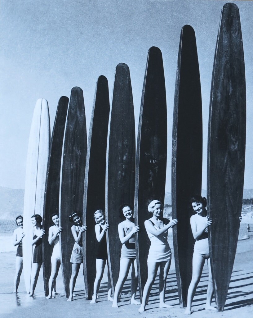 Eight Girls on the Beach With Vintage Longboards - Exhibition