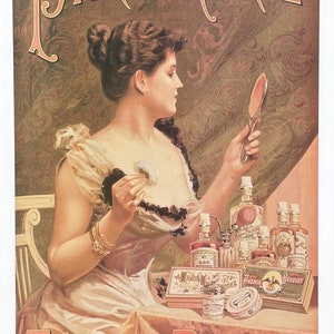 May include: A vintage advertisement for Felix Potin's perfumery featuring a woman in a light pink dress with a black lace bodice, holding a hand mirror and a small white flower. The advertisement features the text "PARFUMERIE FELIX POTIN" and depicts various bottles of perfume and other beauty products.